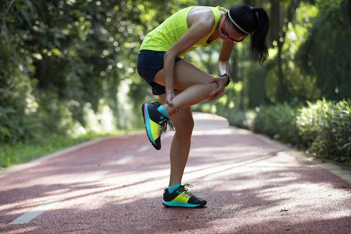 Female runner suffering with pain on sports running injury 