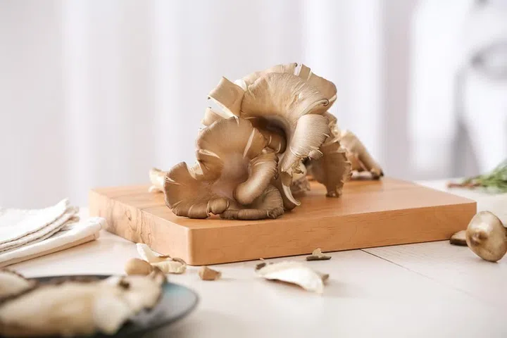 Fresh mushrooms on wooden cutting board