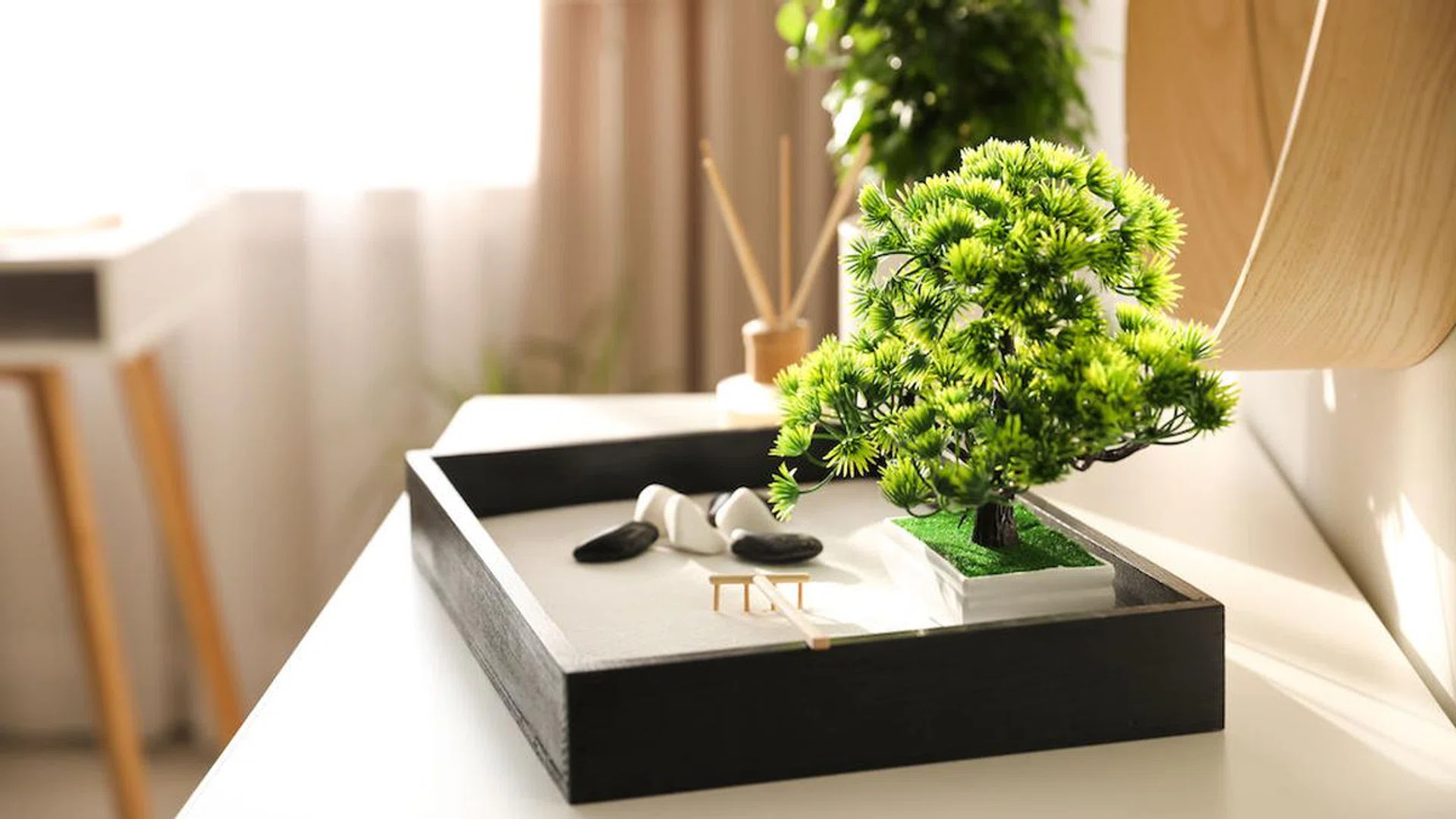 Beautiful miniature zen garden on white table indoors