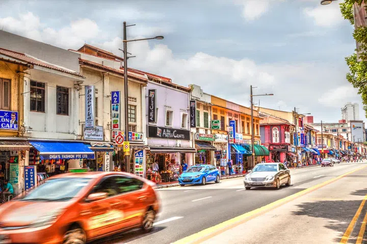 SINGAPORE - MARCH 24, 2015: Old vintage shophouses along vibrant Little India in Singapore. The Indian ethnic neighborhood was once prominent for raising cattle and trading livestock. HDR rendering.