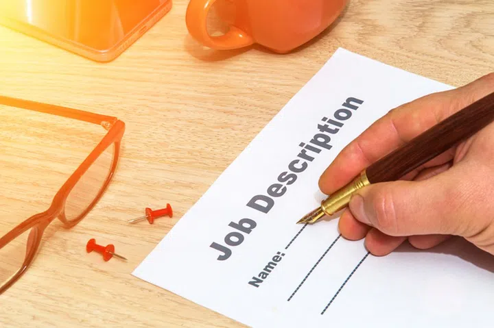 Person fills out a job description form before starting successful strategy