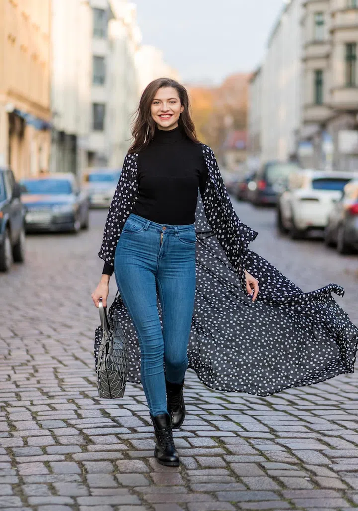BERLIN, GERMANY - NOVEMBER 09: Fata Hasanovic (@fata.hasanovic / model germanys next topmodel) wearing a black turtleneck, high waisted blue denim jeans. black NA KD coat with white dots , black sassy classy heavy boots, silver sassy classy bag on November 9, 2016 in Berlin, Germany. (Photo by Christian Vierig/Getty Images)