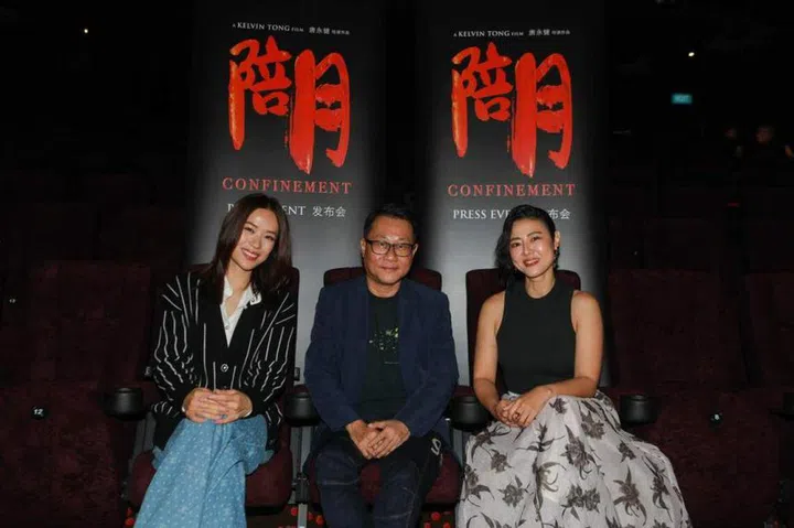 Director Kelvin Tong is flanked by actresses Rebecca Lim (left) and Cynthia Koh at Golden Village Suntec in a press conference for local thriller Confinement. ST PHOTO: RYAN CHIONG