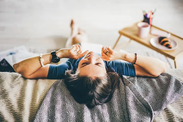 Brunette woman relaxing at home.