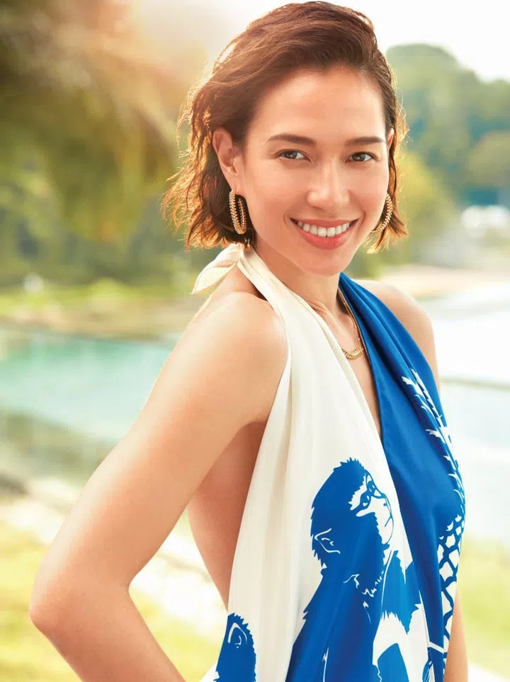  Silk scarf romper from Bottega Veneta; Yellow gold clash de Cartier earrings and necklace, both from Cartier. 