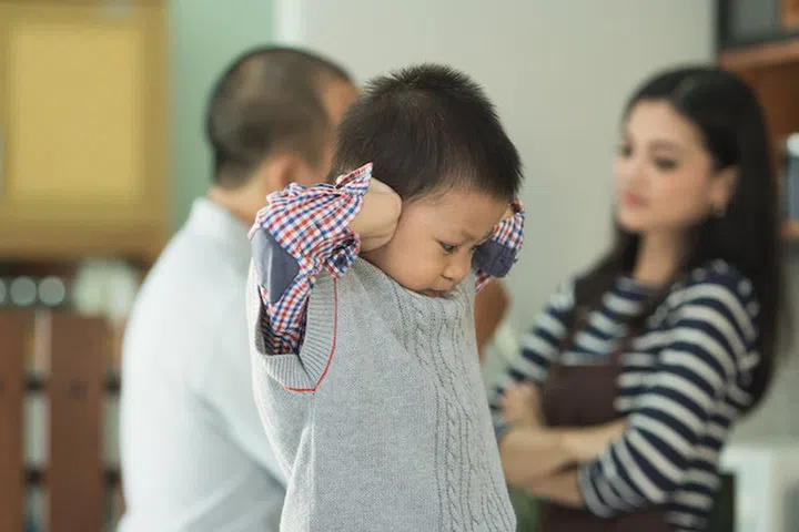 Thirty something couple at home fighting with son between them