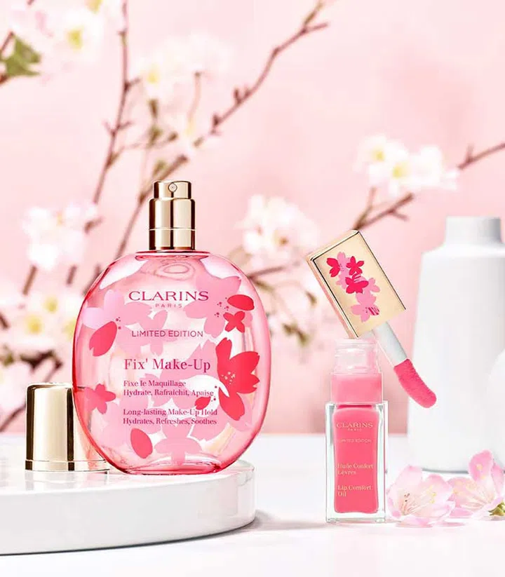 The classic Clarins Lip Comfort Oil No. 14 in pale, baby pink ($34), and the Clarins Fix Make-Up mist in a cherry blossom scent ($49)