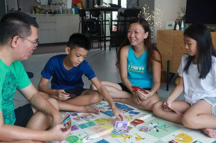 (From left) Mr Malcolm Tan, his son Sozo, wife Jessie and daughter Hannah spend time together as a family playing board games. ST PHOTO: RYAN CHIONG