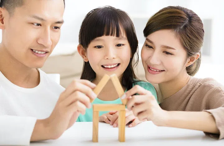 happy family playing with toy blocks