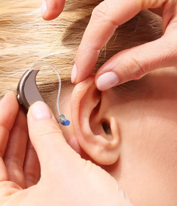 Inserting your hearing instruments. The doctor assumes the woman hearing aid in your ear