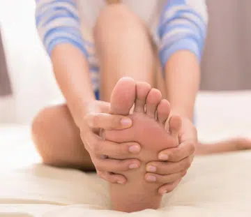 woman holding her foot