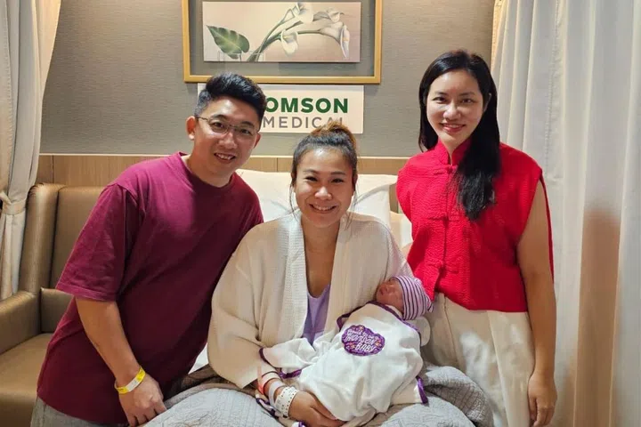 Jacky Hu, 36, and Angie Sia, 31, with their newborn Janric, delivered by Dr Janice Tung (right).