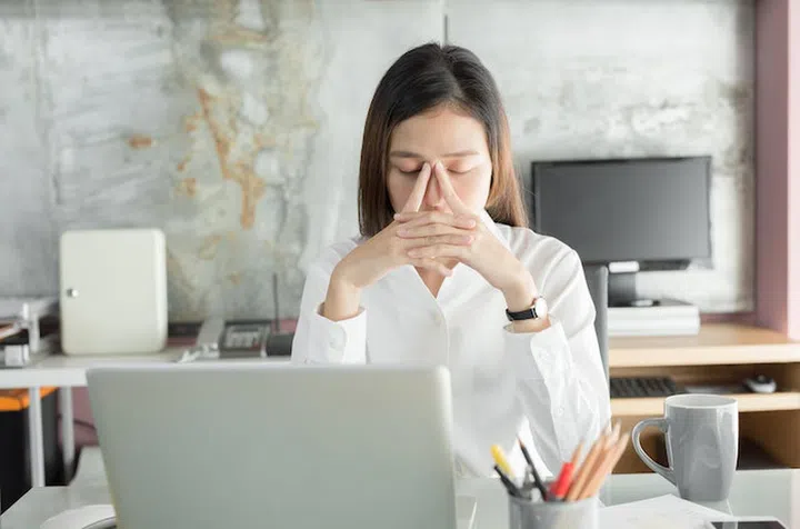 Young business people are suffering from headaches,Asian women Stressful Working with a notebook for a long time,Office syndrome concept