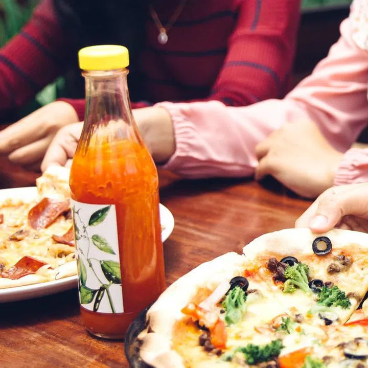 Group Of Young Friends Enjoying Meal In Outdoor Restaurant
