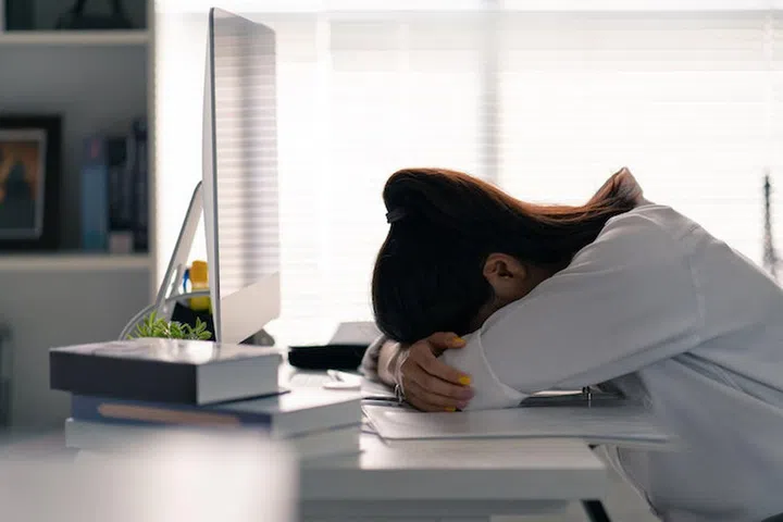 Businesswoman she was lying on the table, she was tired of working in the office.