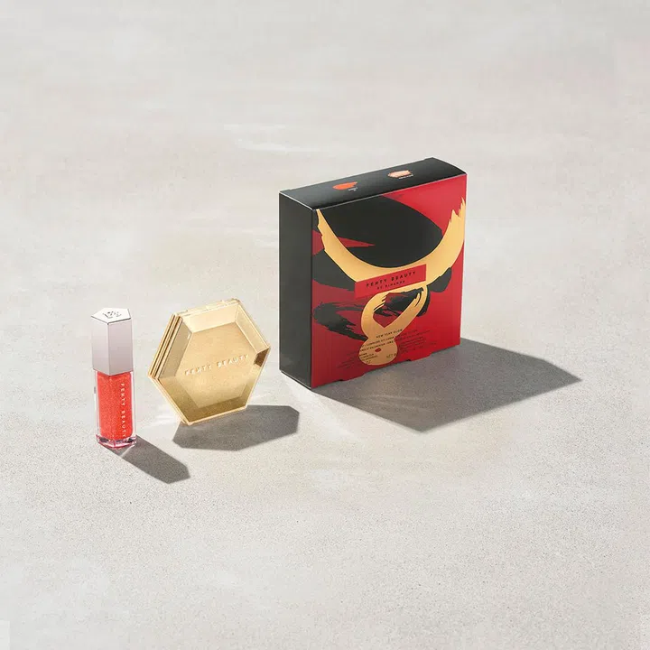 From left: Gloss Bomb Universal Lip Luminiser in Cheeky, and the Diamond Bomb All-Over Diamond Veil in Royal Icing, in a limited edition CNY 2021 box is going for $85