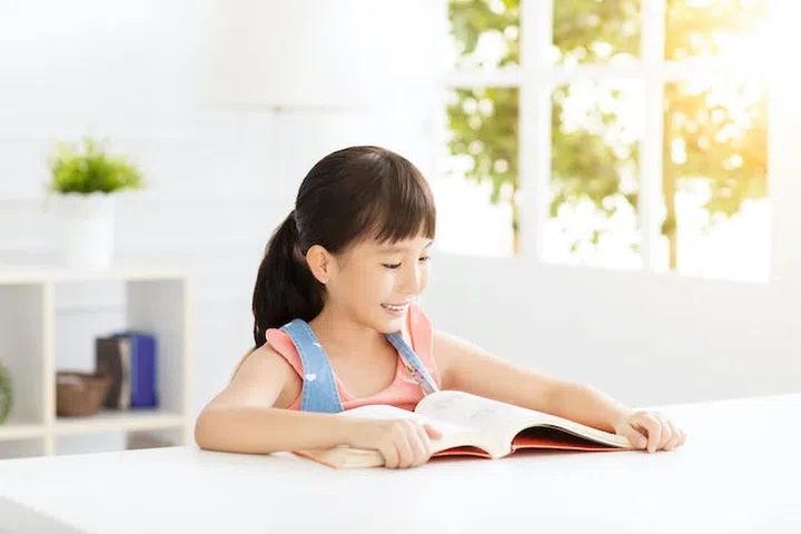 happy little girl study in the living room