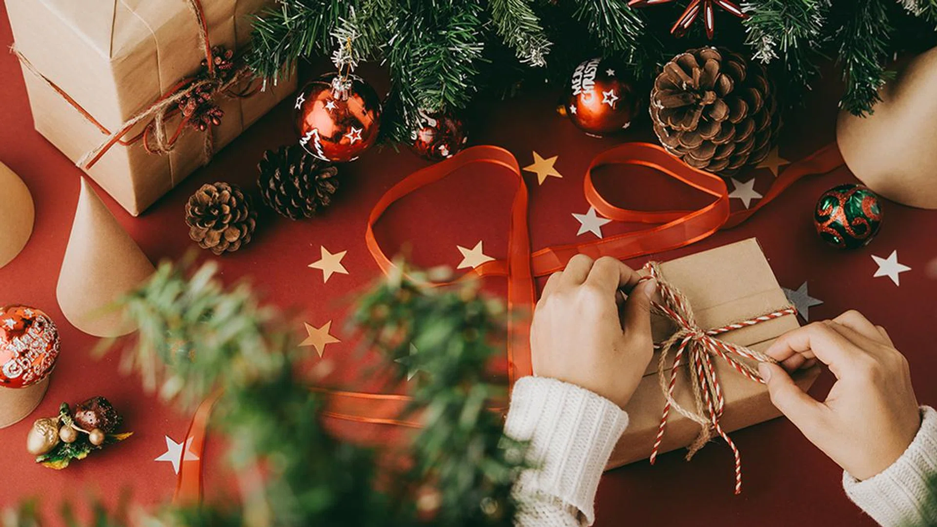 Close-up image of woman wrapping present for New Year