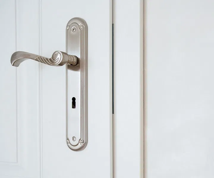 Horizontal view of door-handle in white door
