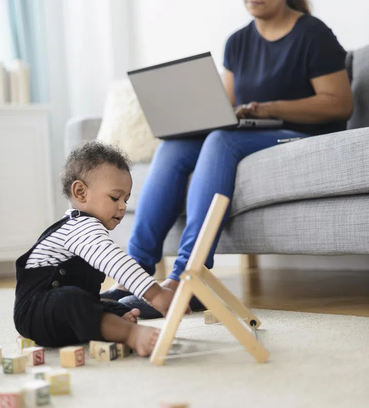 Mixed race mother and baby son relaxing in living room