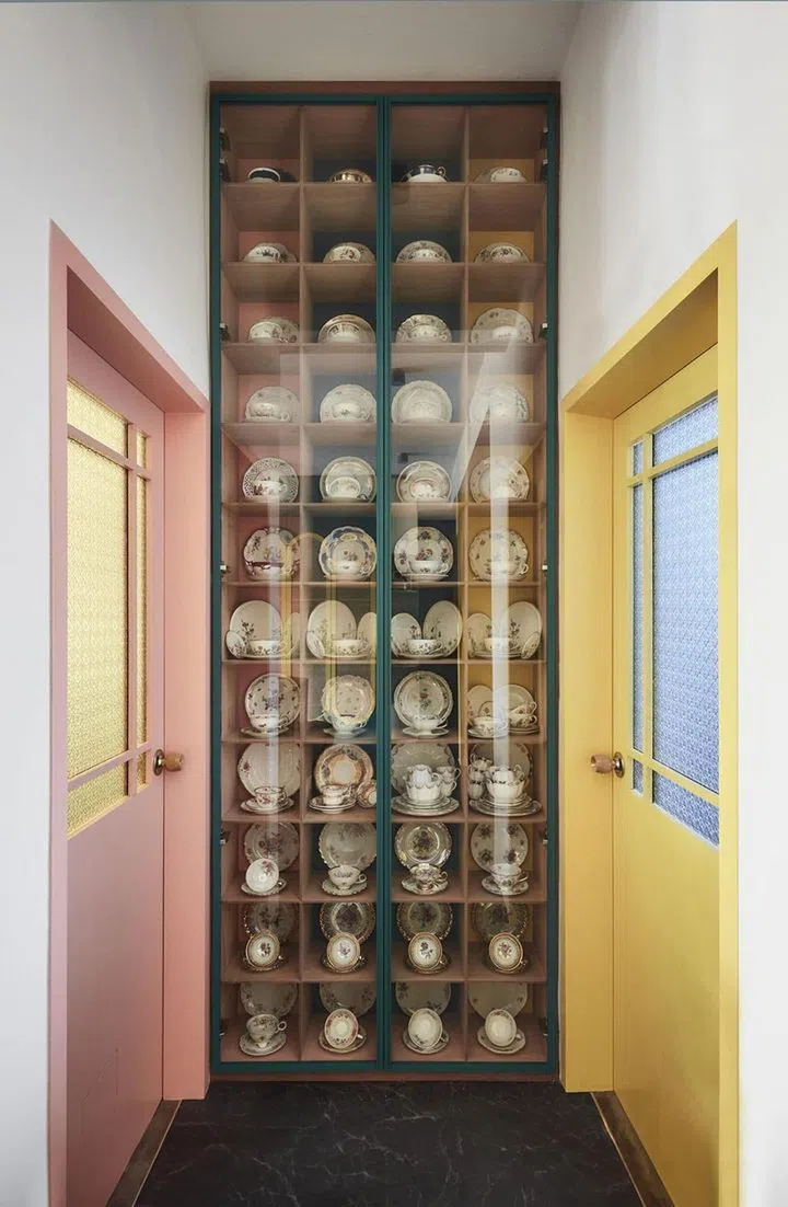 A full-height display for the vintage tea wares in a 2-bedroom walk-up apartment along East Coast Road.