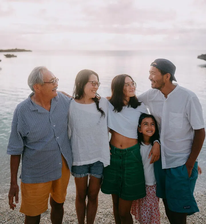 Three generation family having a good time on beach at dusk, Miyako Island, Okinawa, Japan