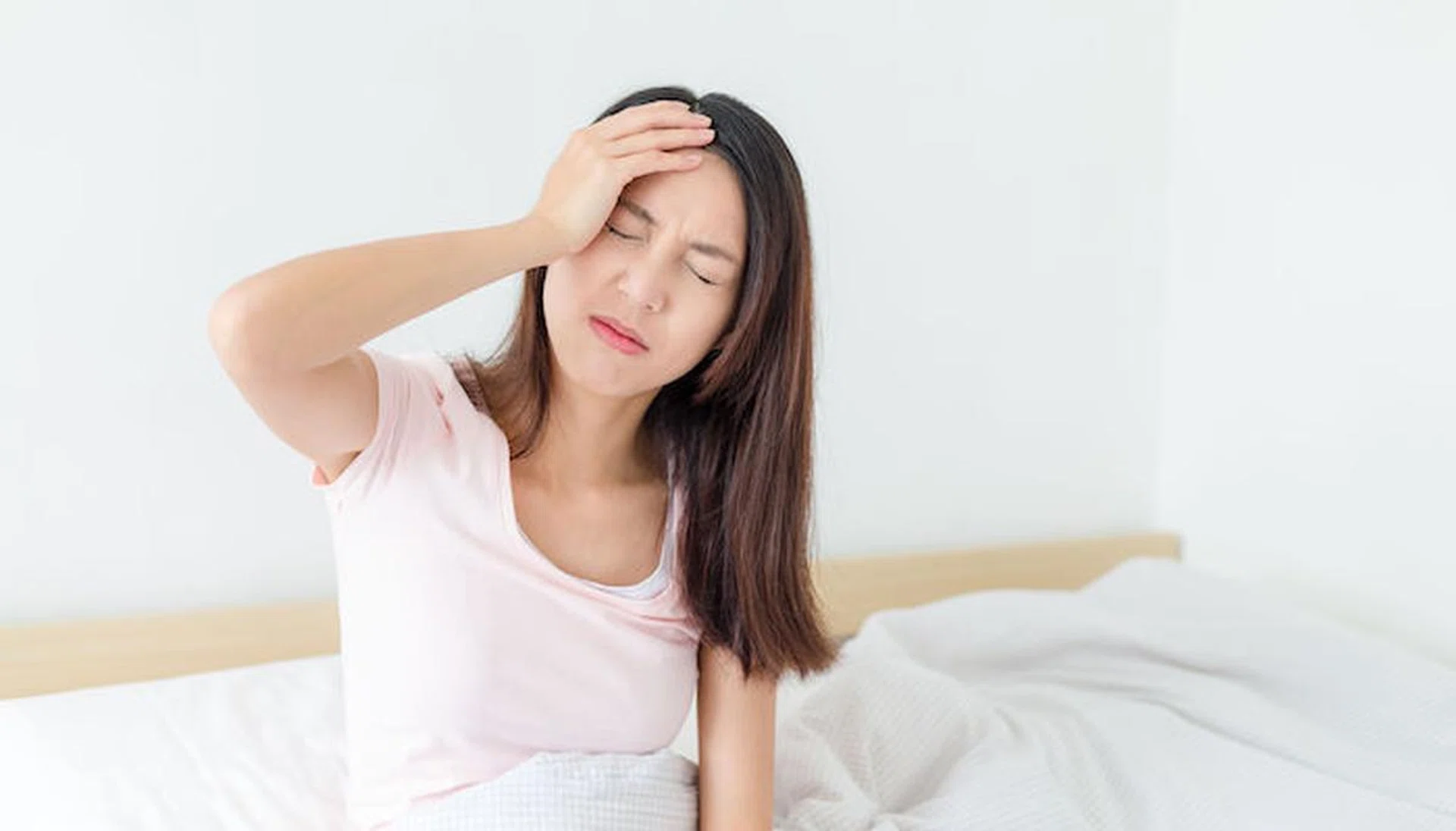 Sick woman on the bed at home