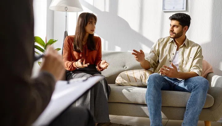 Young family at psychologist counseling meeting. Psychotherapy session. Couple psychological therapy