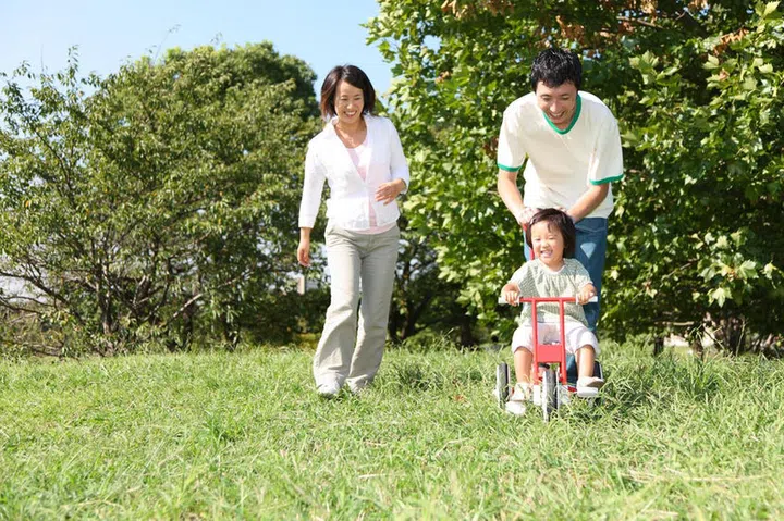 32615525 - japanese family playing in the park