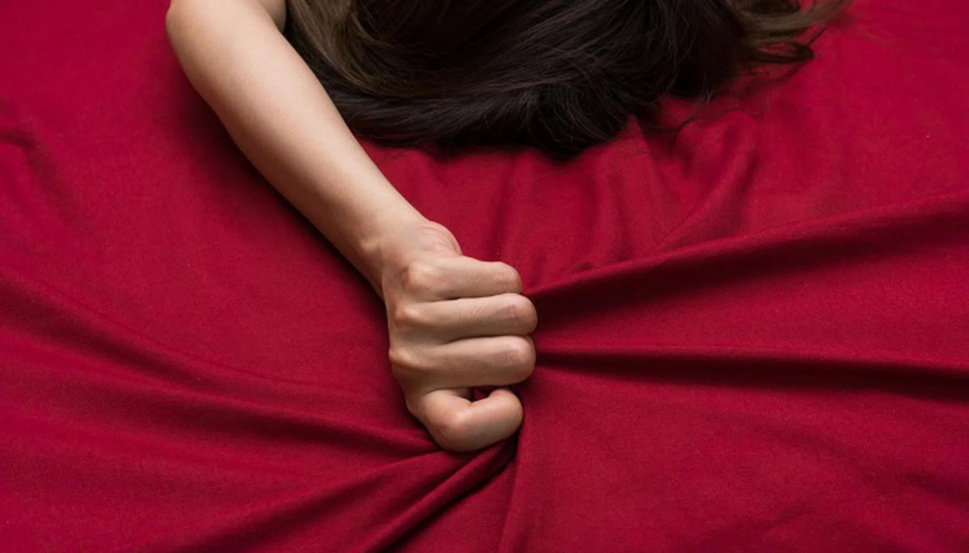 44134802 - hand grasp on bed sheet