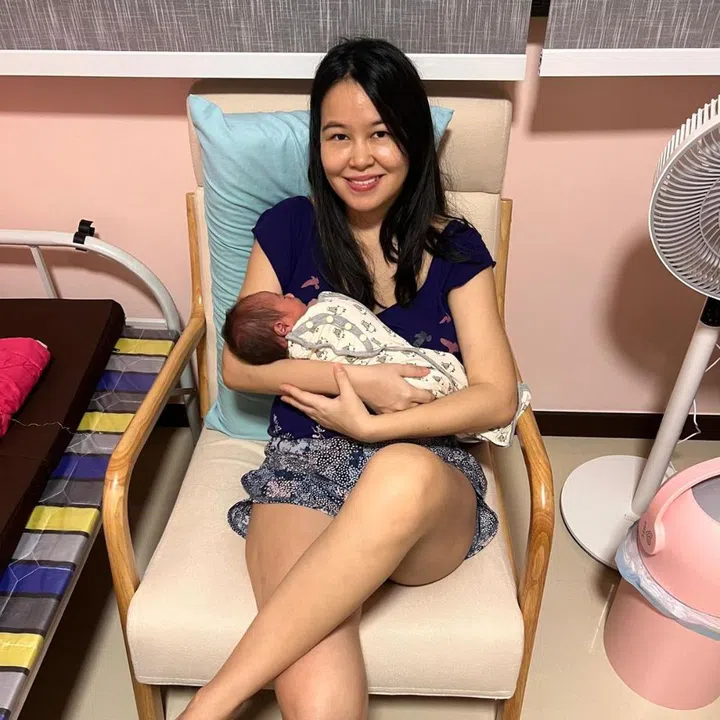 Rebecca Rachel Wong cradling newborn