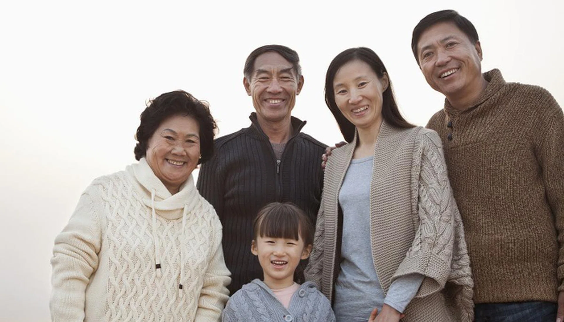 Chinese family standing on beach