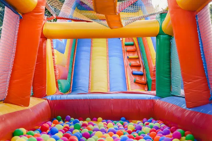 Inflatable castle full of colored balls for children to jump