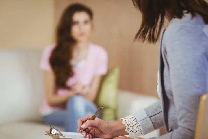 Therapist listening to her patient in therapists office