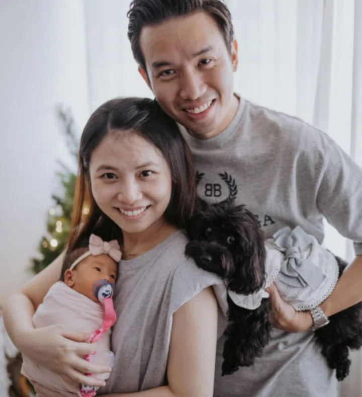 Mr Amos Tan with his wife Carol Ho and their daughter Baelyn. Mr Tan said that with Singaporeans’ workloads, it is tough to take a long paternity leave. Credit: Courtesy of Amos Tan