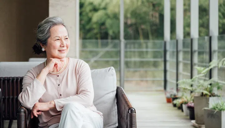 Senior woman sitting on the balcony