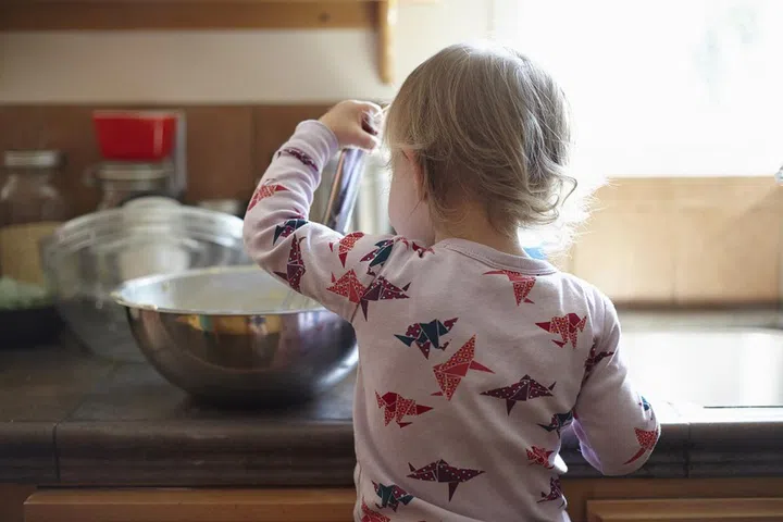 Rear view of toddler baking