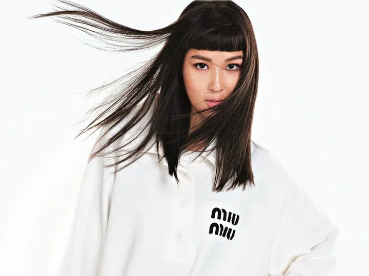 Credit: Knit sweater and knit skirt with feather trimming, Miu Miu.