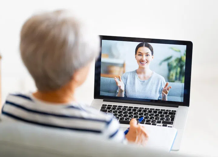Senior woman is using laptop pc for remote work.