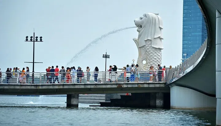 Tourists at the Merlion Park in Singapore.