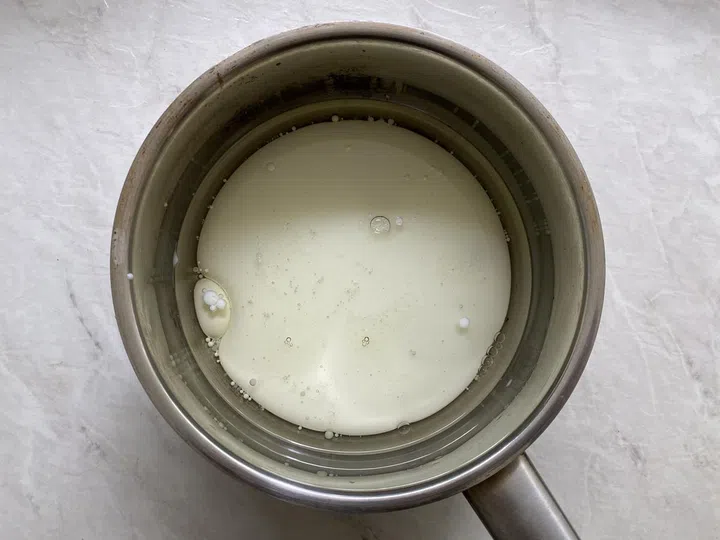 01. Add the oil, water and full cream milk and salt into a saucepan. Place the mixture over high heat.