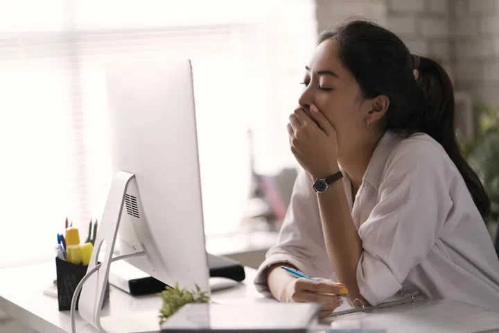 Businesswoman, yawned she was tired of working in an office.