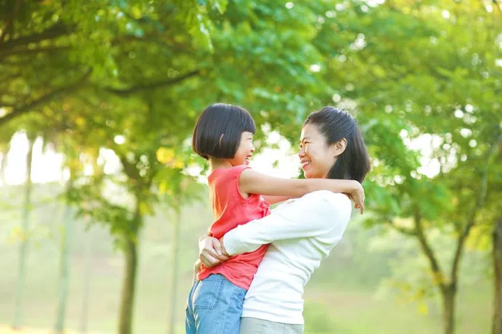 14917202 - asian mother hugging her daughter at outdoor park