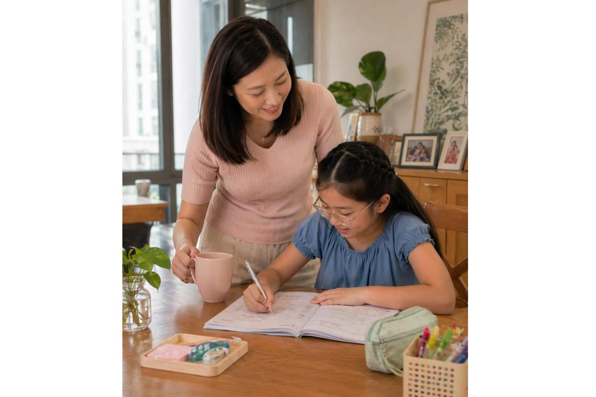Asian mum helping daughter study for the PSLE exam