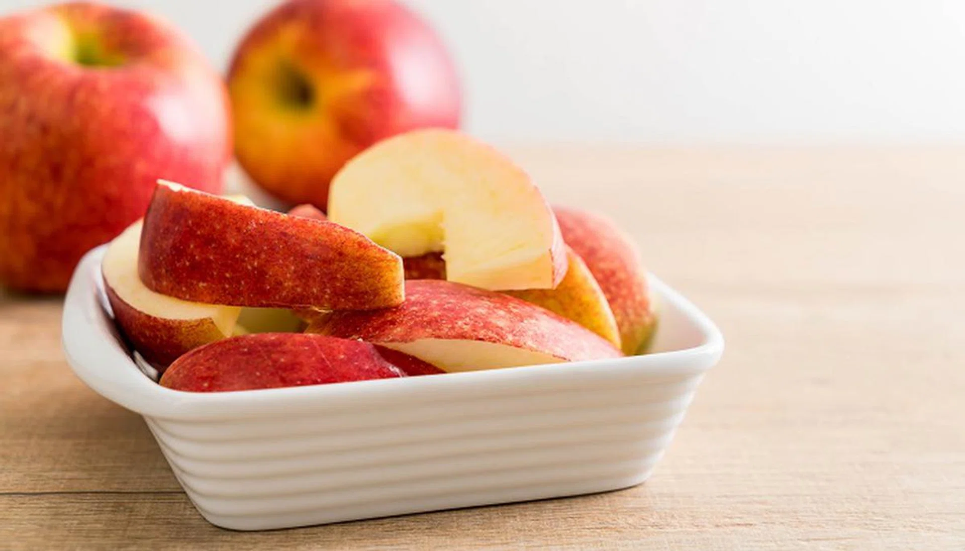 fresh apple sliced in white bowl