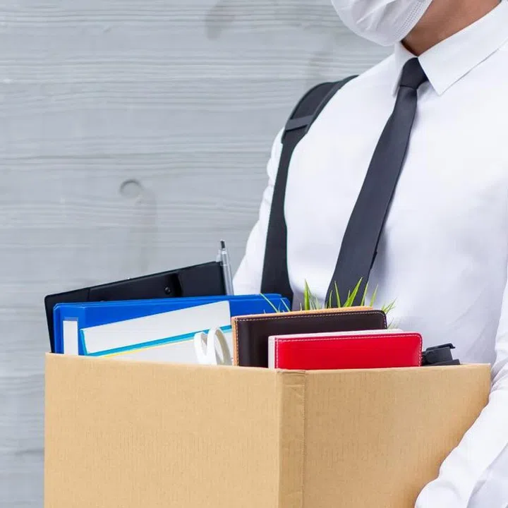 Asian business man wear face mask and he is being fired because of economic downturn due to the covid-19 spread all over the world