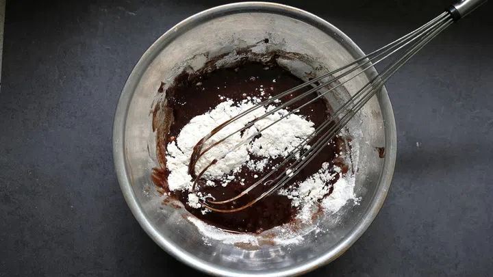 03. Add salt and flour to the mixture and stir well till smooth.