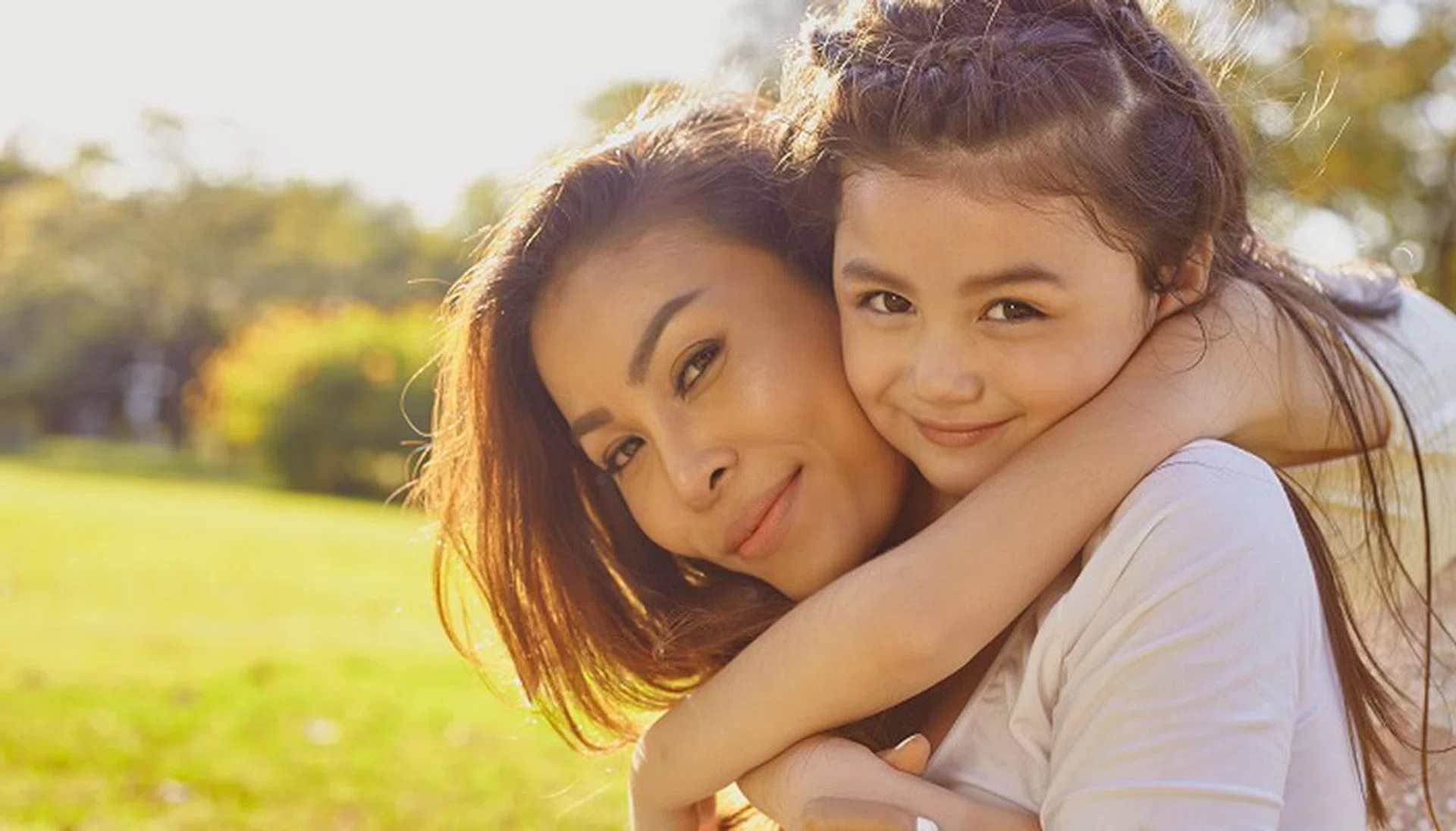 50744119 - lifestyle portrait mom and daughter in happines at the outside in the meadow