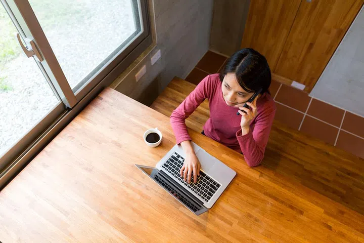 Top view of woman use of laptop computer with make a call