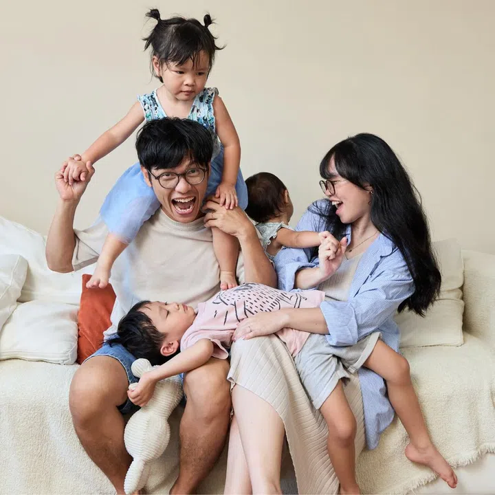 Mavis Huang and Joel Peh with their children in their living room